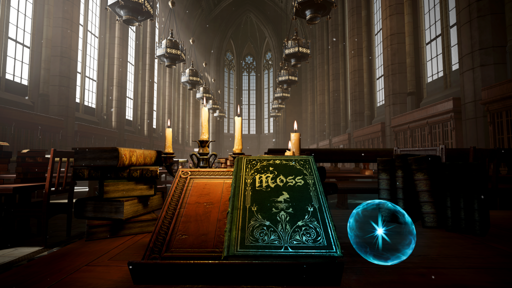 An image from the game Moss of the inside of a stone building. The building looks a little like a cathedral, with large Gothic arched windows and chandeliers hanging from the ceiling. The room is full of dark wooden desks, chairs, and study carrels. The player stands in front of a book stand that holds a beautifully bound, dark green book. The book is titled "Moss" and is covered in golden, vine-like embellishments.