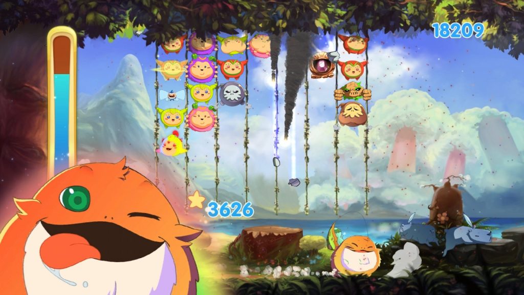 A 2-D cartoon image of gameplay from Critter Crunch. A number of small, round creatures fall along a series of rows, in front of a watercolour background of blue sky, mountains, and a lake. Biggs - an orange, furry creature with a big mouth and big tongue- 