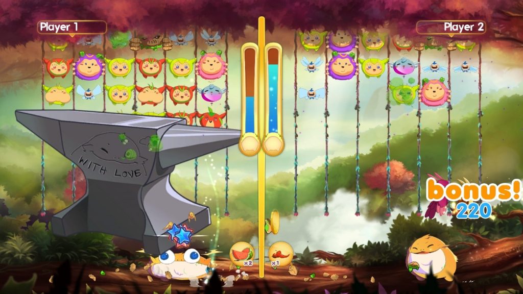 A 2-D cartoon image of multiplayer gameplay from Critter Crunch. The same rounded creatures are falling from the top of the screen. Player 1's Biggs is being crushed by a comically large anvil, which has an image of Biggs and the words "with love" carved into it.