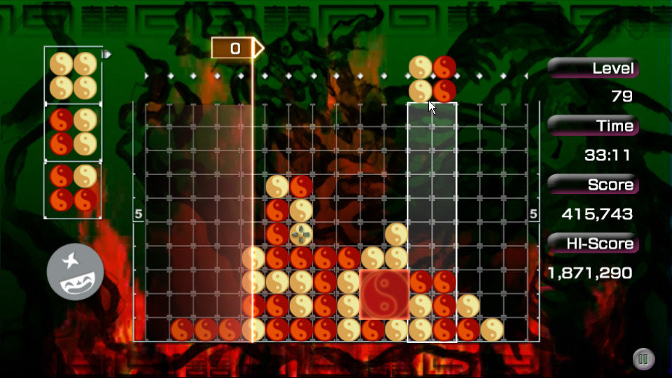 An image of the falling block puzzler "lumines". The blocks in this level are orange and yellow Yin and Yang symbols. In the background, there's an indistinct image of bugs.