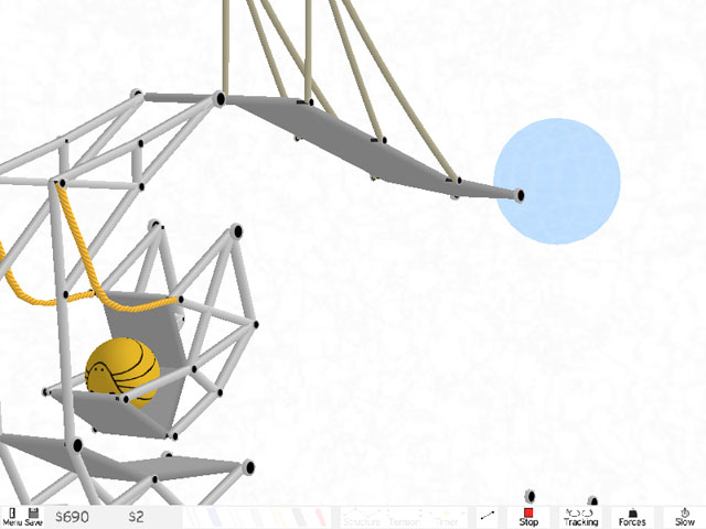 An image of the game "Armadillo Run". A yellow armadillo rolled in a ball sits on a metal contraption, which is set up to be moved by ropes as part of a larger metallic structure.